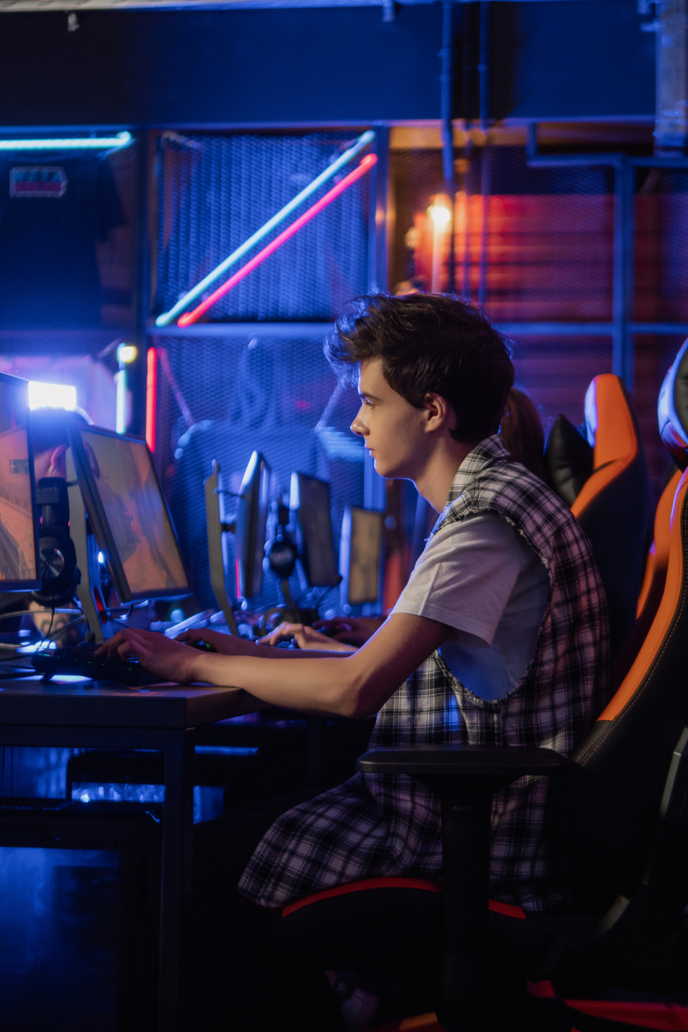 Boy Sitting on Gaming Chair while Playing Video Games